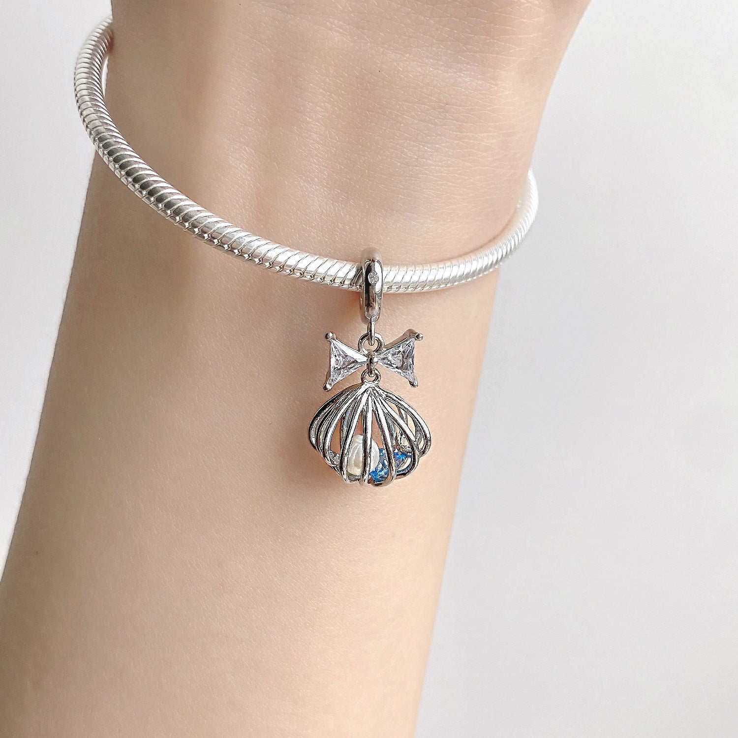 Kristallkäfig Charm am Handgelenk